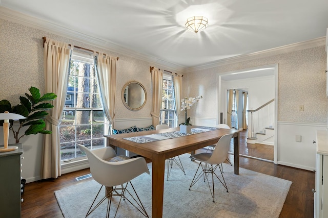 dining space featuring a healthy amount of sunlight, crown molding, and dark wood-type flooring