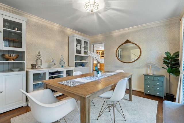 dining space with ornamental molding and dark wood-type flooring