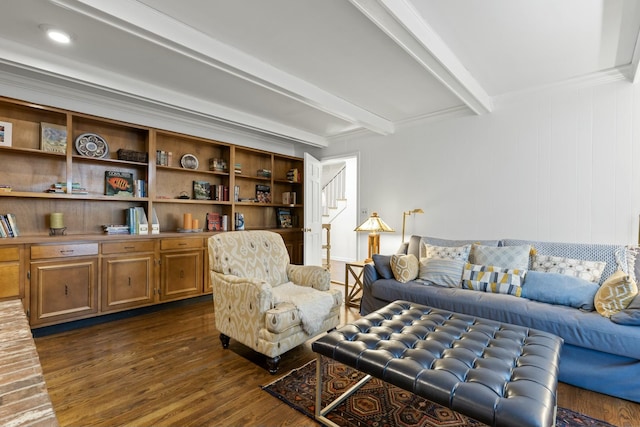 living room with dark hardwood / wood-style flooring, beamed ceiling, and ornamental molding