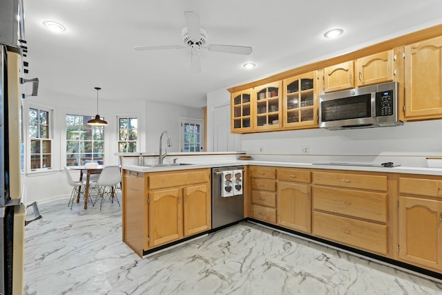 kitchen featuring pendant lighting, sink, ceiling fan, appliances with stainless steel finishes, and kitchen peninsula