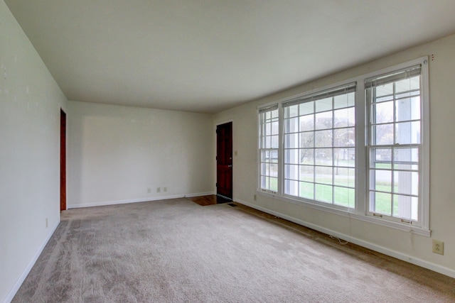 carpeted empty room with a wealth of natural light