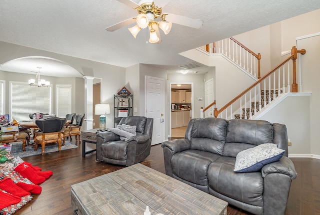 living room featuring a textured ceiling, dark wood-type flooring, and ceiling fan with notable chandelier