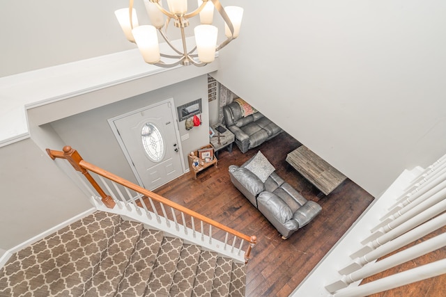 entrance foyer with a chandelier, dark hardwood / wood-style flooring, and vaulted ceiling