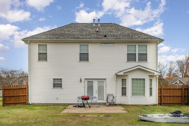 back of property featuring french doors, a yard, and a patio area