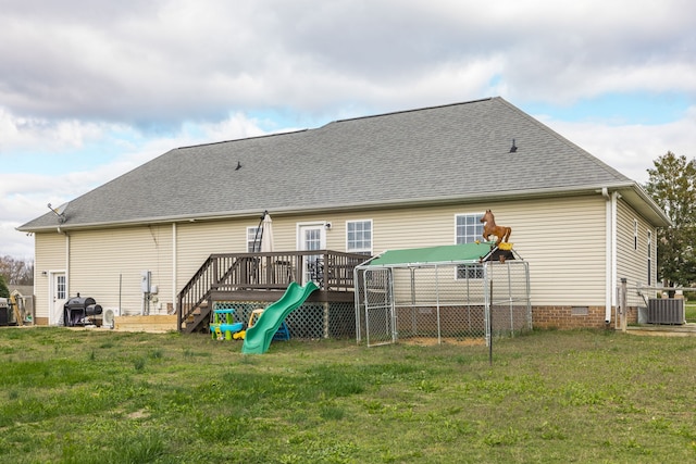 rear view of house featuring a yard, cooling unit, and a deck