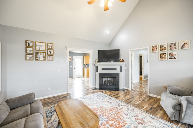 living room featuring ceiling fan, wood-type flooring, and high vaulted ceiling