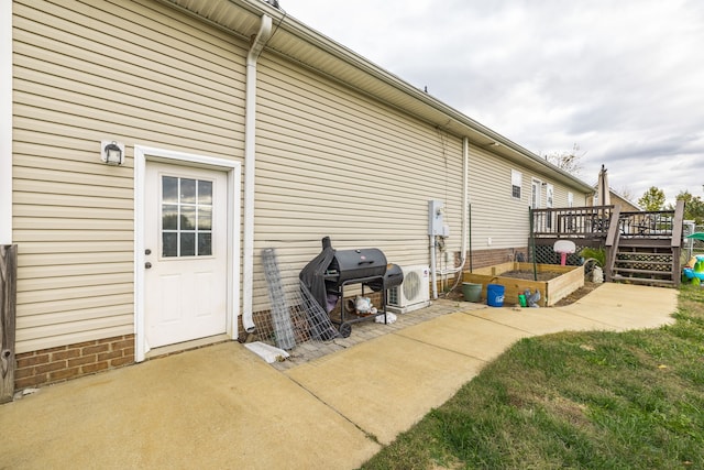 exterior space featuring ac unit, a yard, and a wooden deck