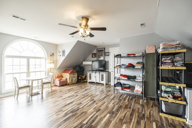 playroom with ceiling fan, lofted ceiling, and hardwood / wood-style flooring