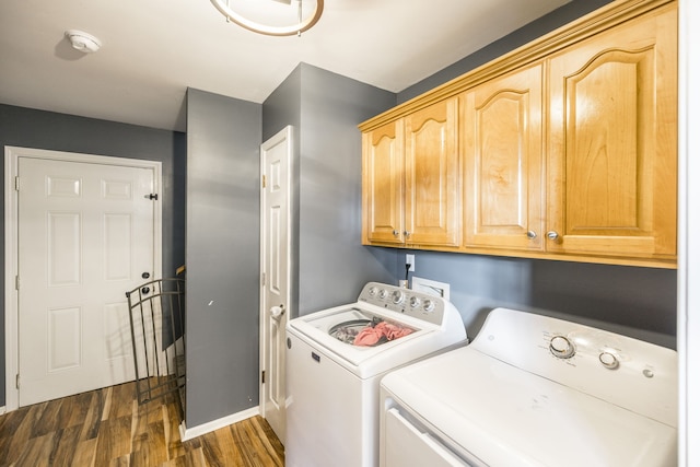 washroom with dark hardwood / wood-style flooring, cabinets, and independent washer and dryer