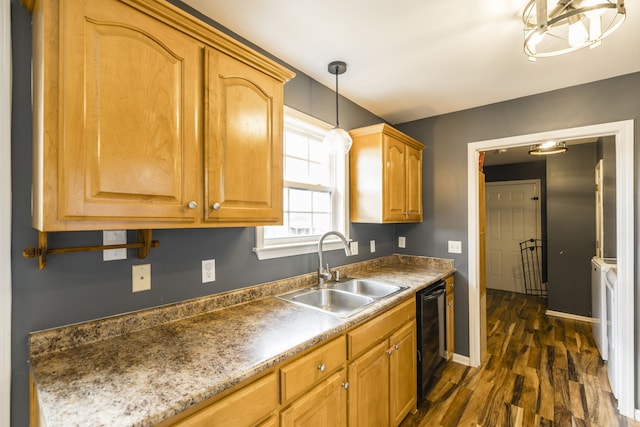 kitchen with pendant lighting, washer and clothes dryer, dark wood-type flooring, and sink