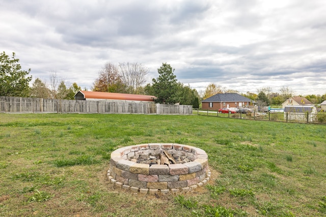 view of yard with an outdoor fire pit