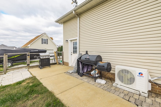 view of patio / terrace featuring a grill and ac unit