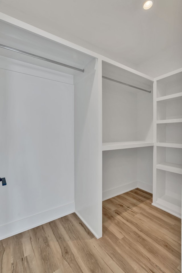 walk in closet with wood-type flooring