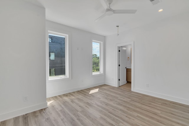 empty room featuring ceiling fan and light hardwood / wood-style floors