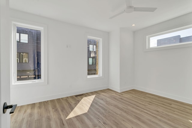 empty room with ceiling fan and light wood-type flooring