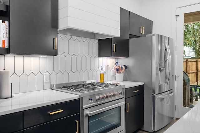 kitchen with custom exhaust hood, light stone counters, appliances with stainless steel finishes, and tasteful backsplash