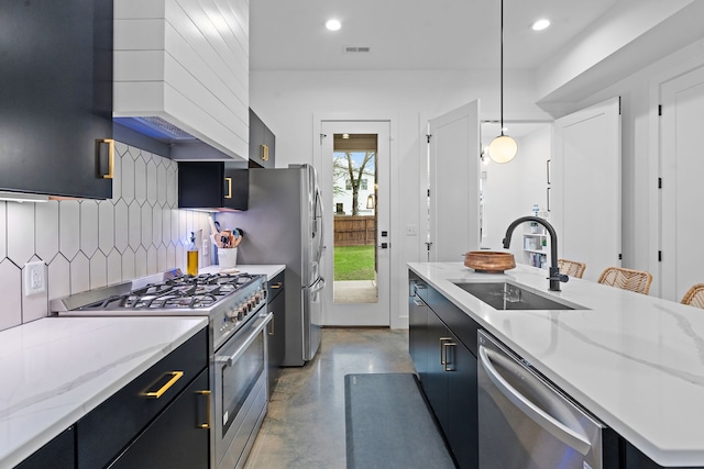 kitchen with backsplash, sink, hanging light fixtures, concrete floors, and stainless steel appliances