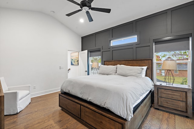 bedroom featuring hardwood / wood-style floors, ceiling fan, lofted ceiling, and multiple windows