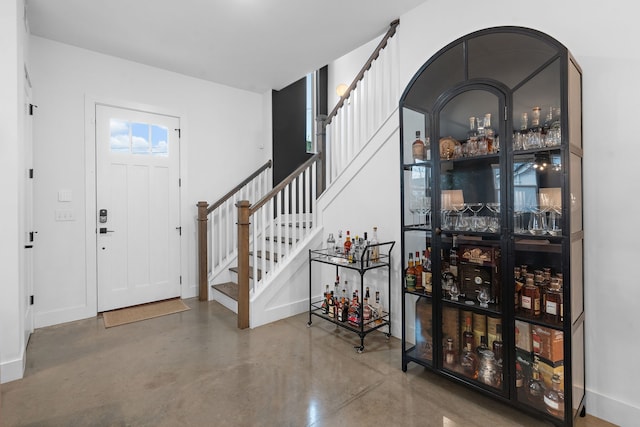 foyer entrance featuring concrete flooring