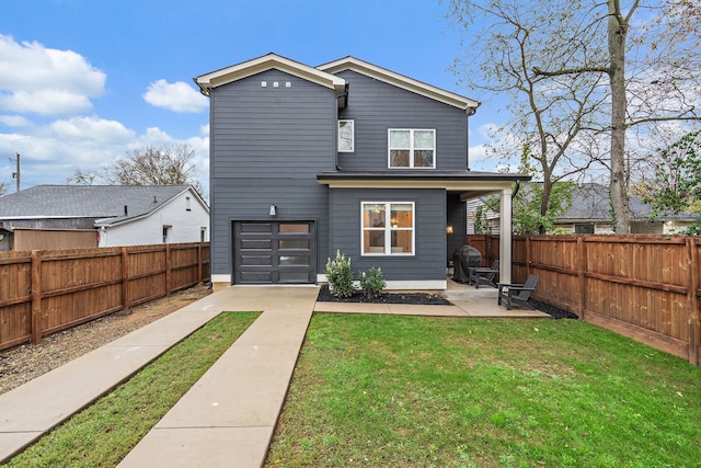 rear view of property featuring a patio, a garage, and a lawn