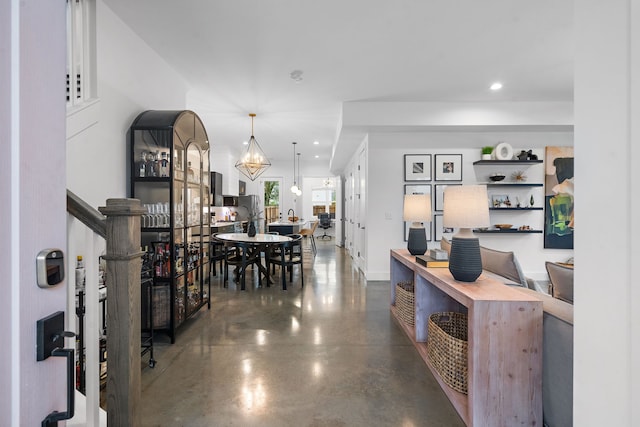 interior space featuring pendant lighting and a chandelier