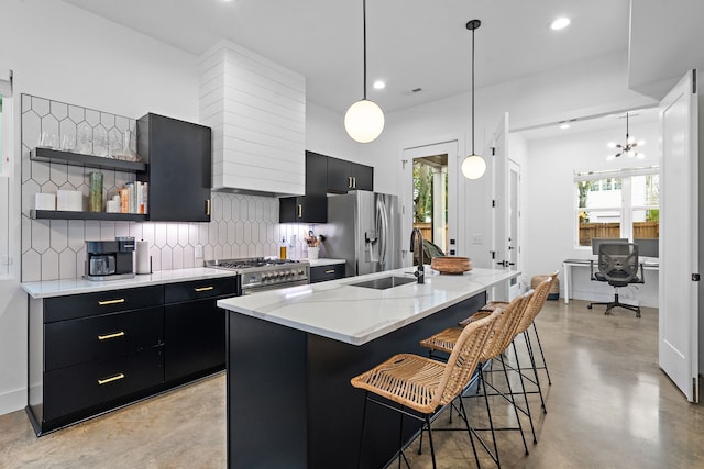 kitchen featuring hanging light fixtures, a breakfast bar, stainless steel appliances, and sink