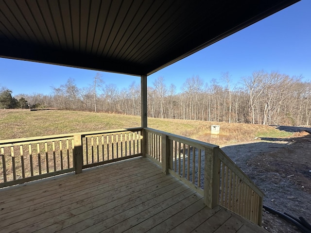 wooden terrace with a lawn