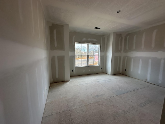 unfurnished room with a textured ceiling and visible vents