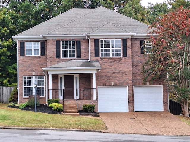 view of front facade with a garage and a front lawn