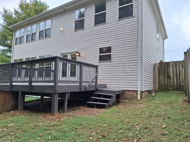 rear view of property with a lawn and a deck