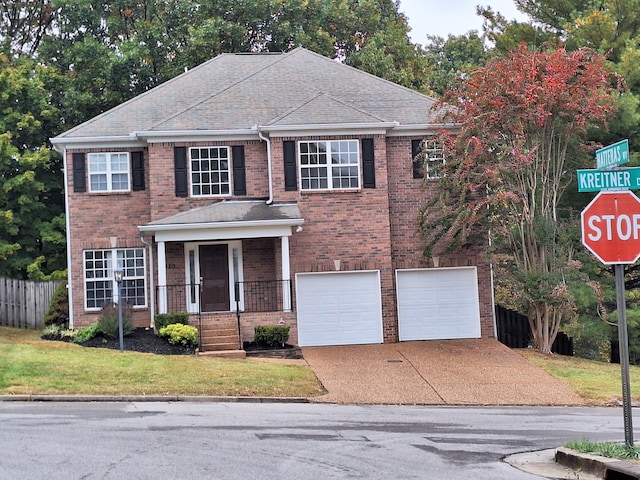 view of front facade featuring a garage and a front lawn