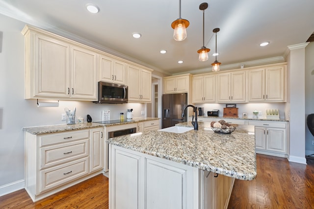 kitchen with decorative light fixtures, wood-type flooring, stainless steel appliances, and a kitchen island with sink