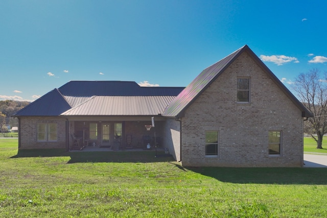 back of house featuring a yard and a patio