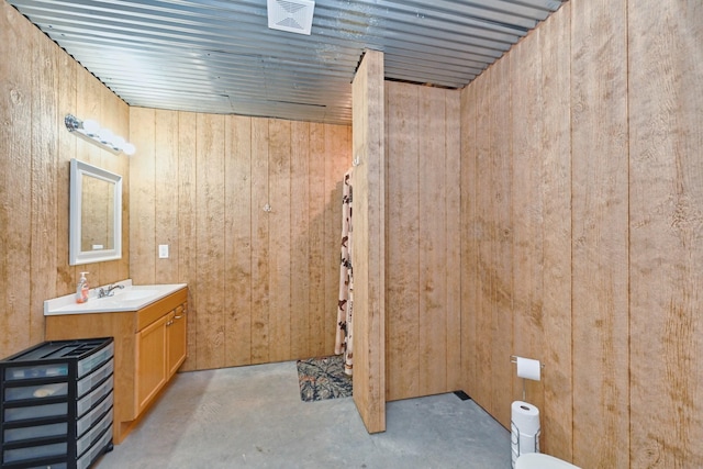 2189 Double Branch Rd, Columbia, TN 38401 - bathroom featuring concrete flooring, vanity, and wooden walls