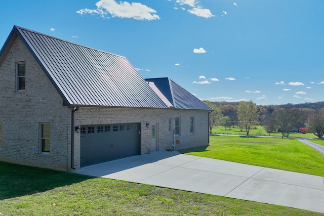 view of side of property with a lawn and a garage