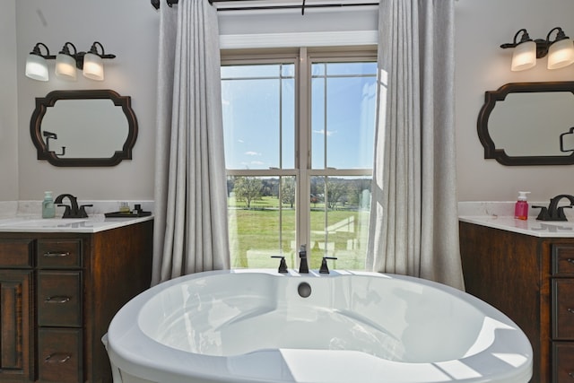 bathroom with a bathing tub and vanity