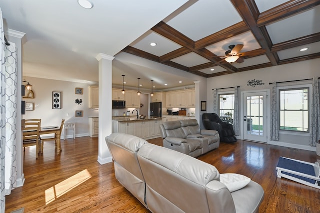 living room with hardwood / wood-style floors, ceiling fan, beamed ceiling, and coffered ceiling