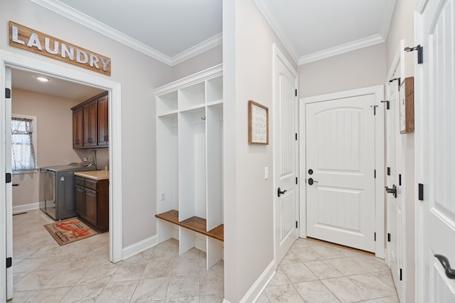 mudroom with independent washer and dryer, light tile patterned flooring, and ornamental molding