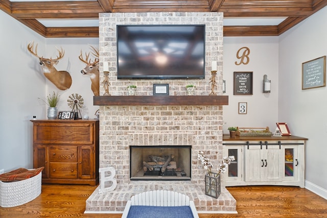 living room featuring hardwood / wood-style flooring, beam ceiling, and a fireplace