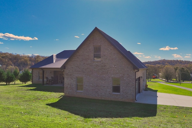 view of property exterior featuring a yard and a garage