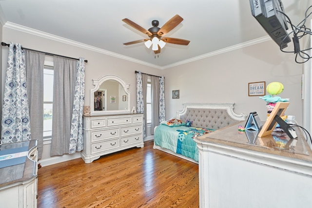 bedroom with ceiling fan, wood-type flooring, and crown molding