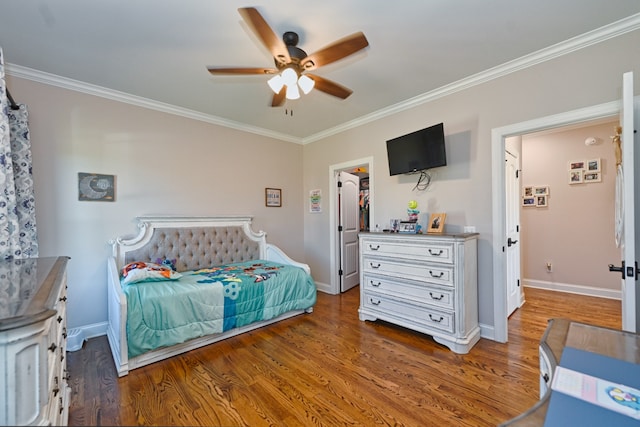 bedroom featuring a walk in closet, ceiling fan, crown molding, and dark hardwood / wood-style floors