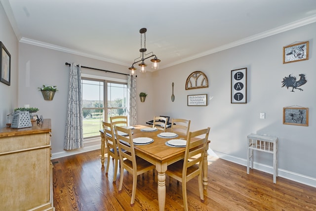 dining space with a chandelier, hardwood / wood-style flooring, and crown molding