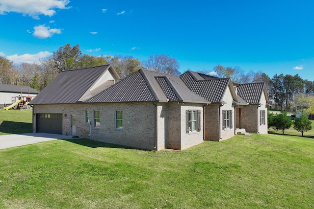 2189 Double Branch Rd, Columbia, TN 38401 - view of home's exterior featuring an attached garage, metal roof, concrete driveway, a yard, and brick siding