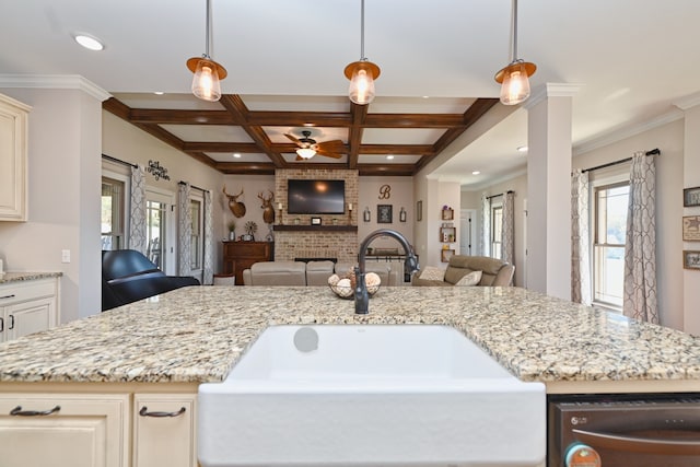 kitchen featuring a healthy amount of sunlight, sink, and hanging light fixtures