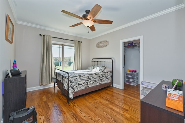 bedroom with dark hardwood / wood-style flooring, a closet, ceiling fan, and ornamental molding