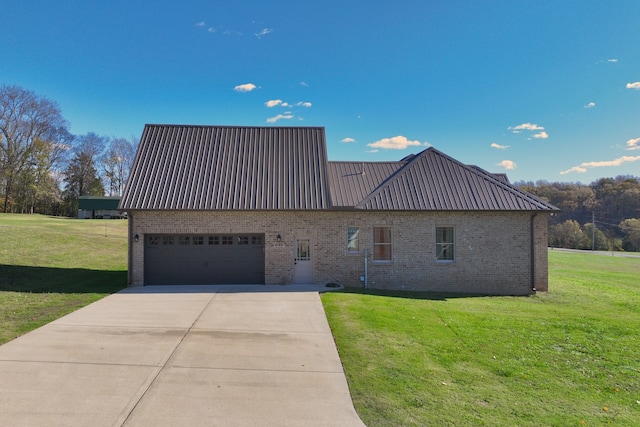 view of front of home with a garage and a front lawn