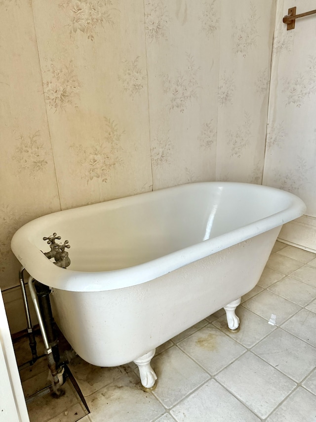 bathroom featuring tile patterned floors and a bath