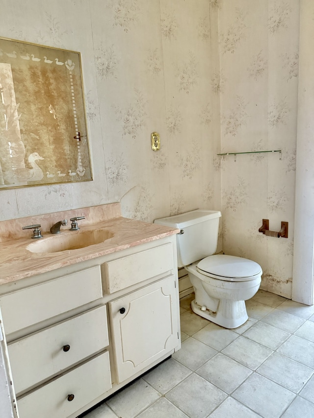 bathroom with tile patterned floors, vanity, and toilet