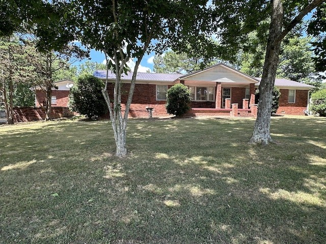 ranch-style house with a front lawn and covered porch